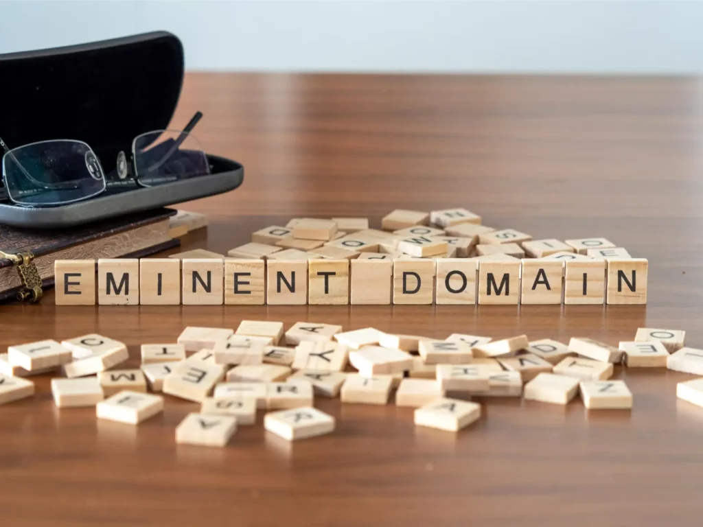 Eminent domain spelled out with wooden blocks | Sewell Sewell Beard LLC